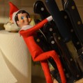 Elf on a Shelf playing with knives