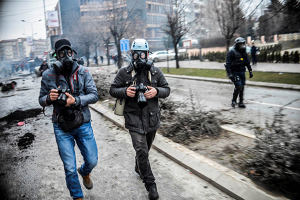 Photographer Visar Kryeziu, left, covers riots in Kosovo's capital Pristina, Tuesday, Jan. 27, 2015. Thousands of protesters clashed with police for hours in the city's streets, leaving a trail of destruction behind them. More than 80 people, including over 50 policemen, were injured, while 160 were detained. (Photo by Petrit Rrahmani)