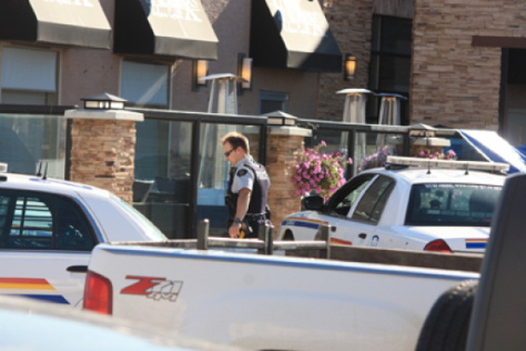 Dawson Creek RCMP await the arrival of IIO investigators outside the Fixx Urban Grill restaurant, where a man was shot dead by police Thursday night outside a Site C open house. Police held the scene while members of the independent police investigations office flew in from Vancouver.